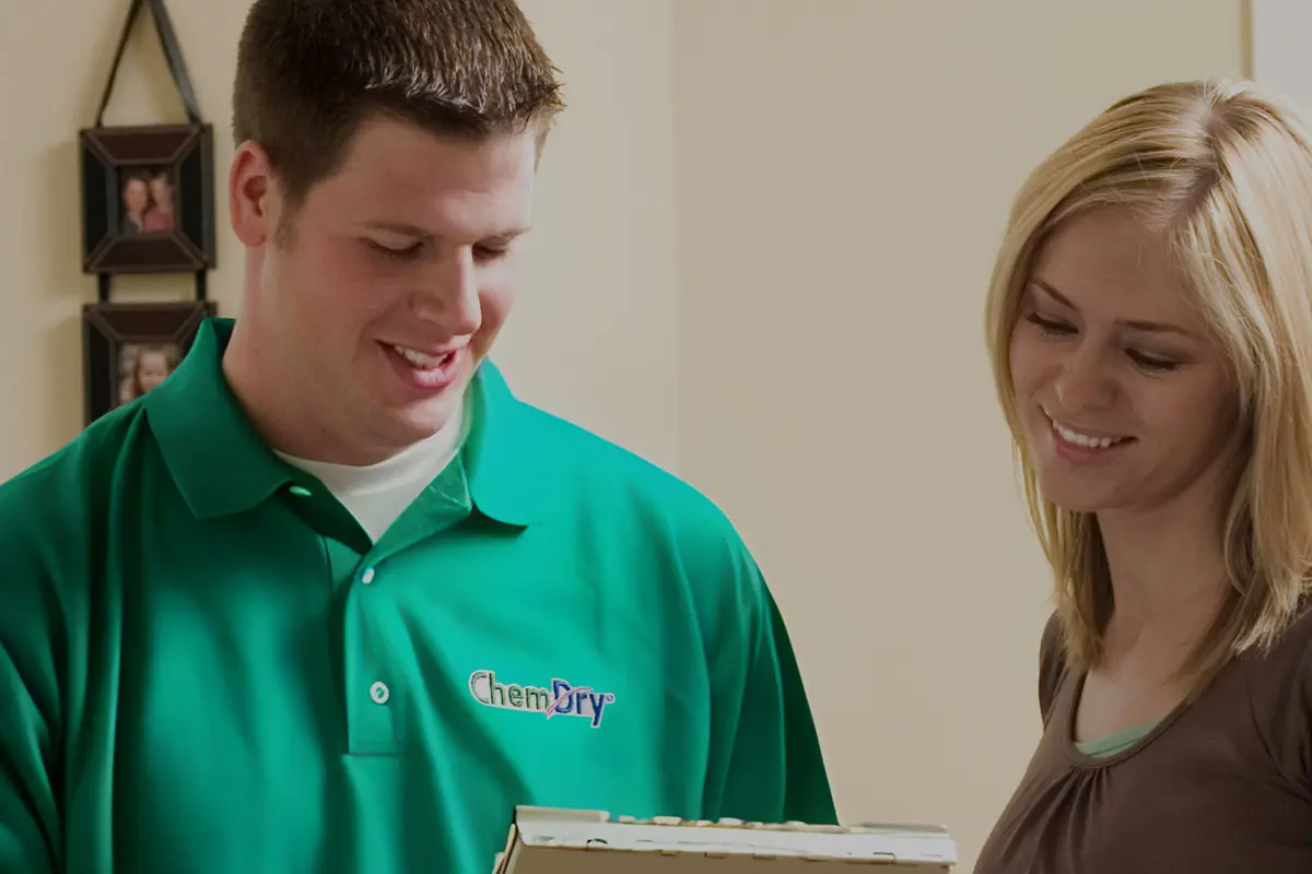 A Chem-Dry technician going over a job with a home owner